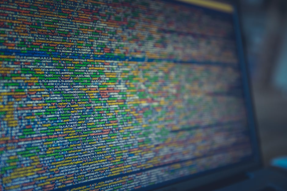 A computer screen displaying a dense, colorful code editor filled with lines of JavaScript or similar programming language, featuring multicolored syntax highlighting such as blue, green, yellow, and